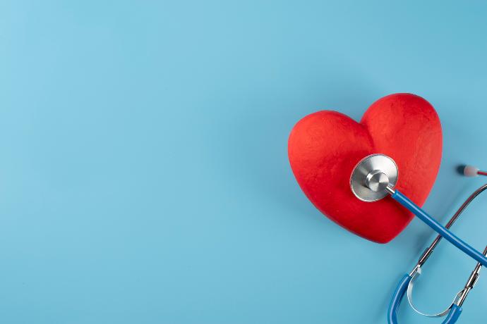 A stethoscope with red heart pillow