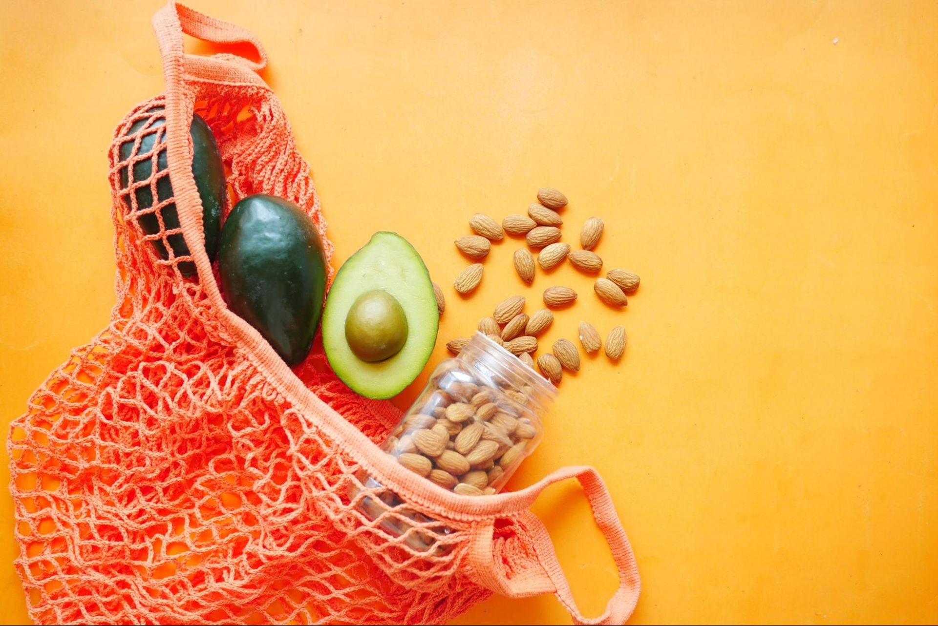 A bag with avocado and almond in a net bag