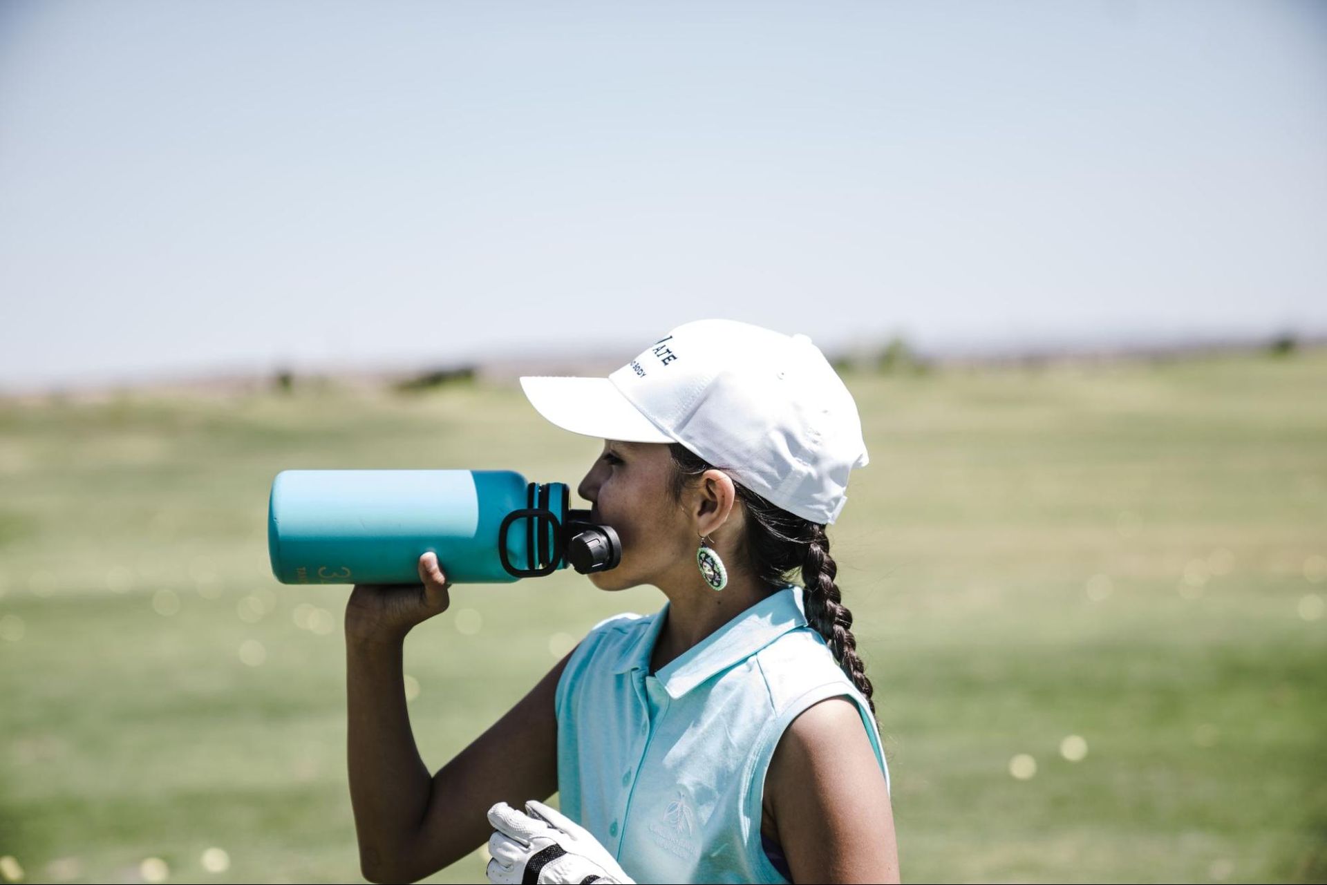 A girl drinking water in a insulated mug