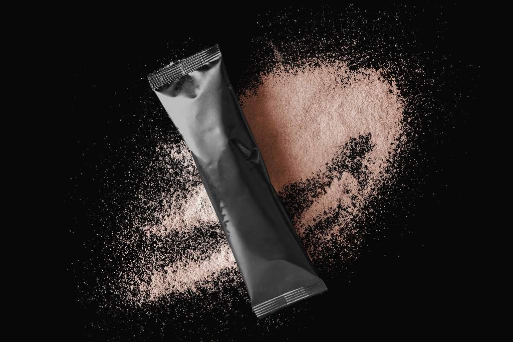 Collagen Powder in a black tetra pack on a black background