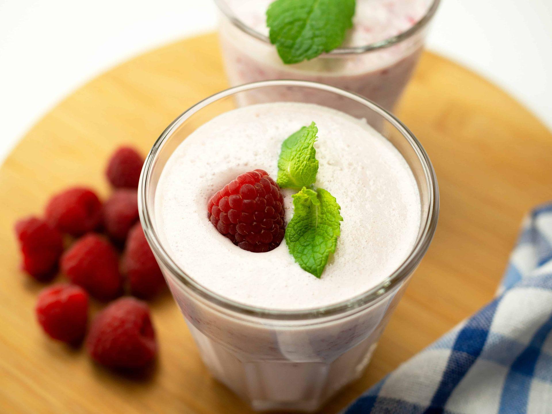 Protein shake with cranberry on a glass cup