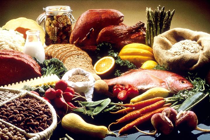 A table full of healthy foods such as fish, vegetables and legumes