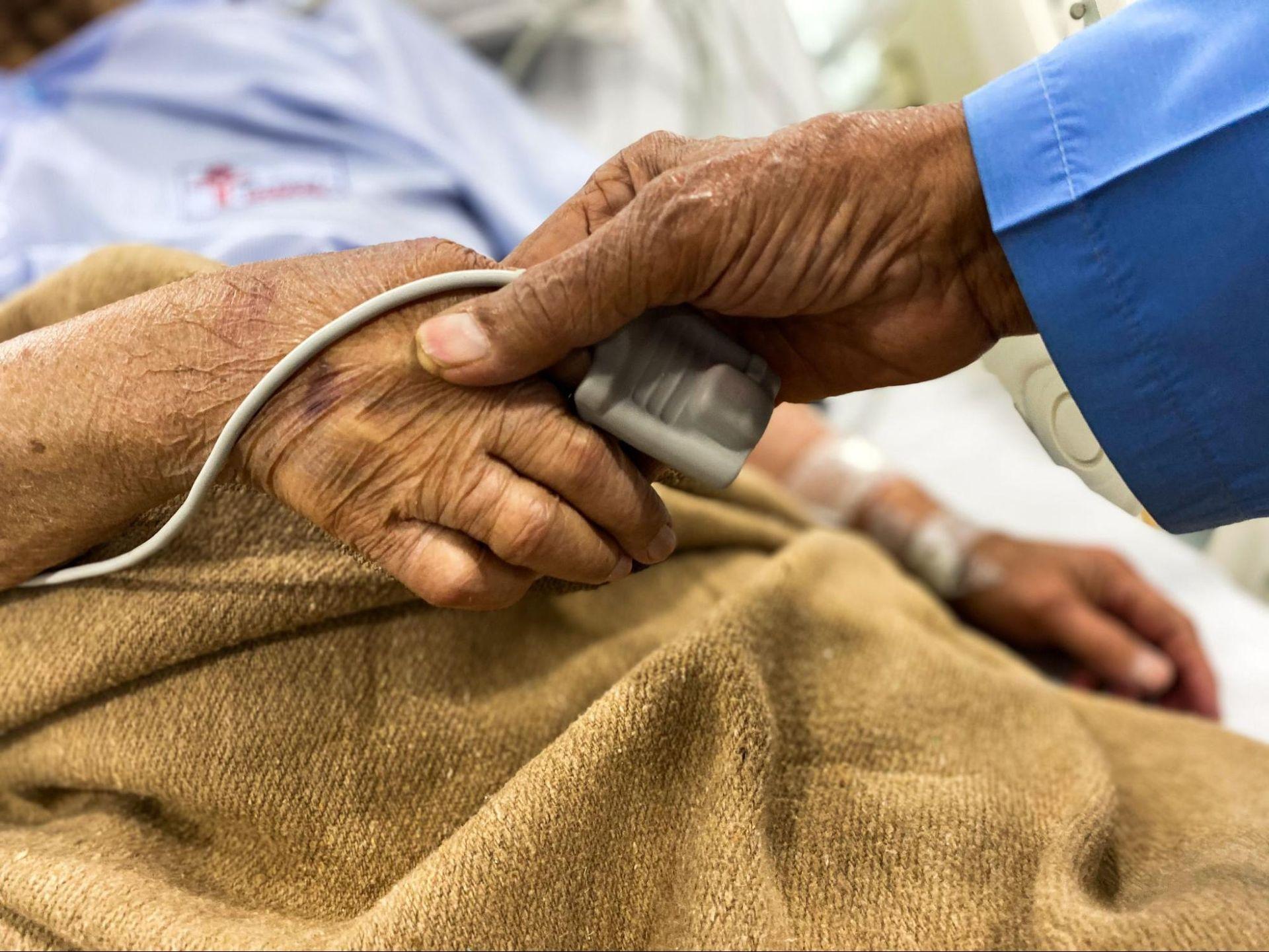 an old patient lying the hospital bed