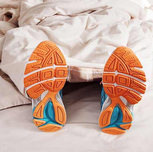 Athlete sleeping with sneakers on 