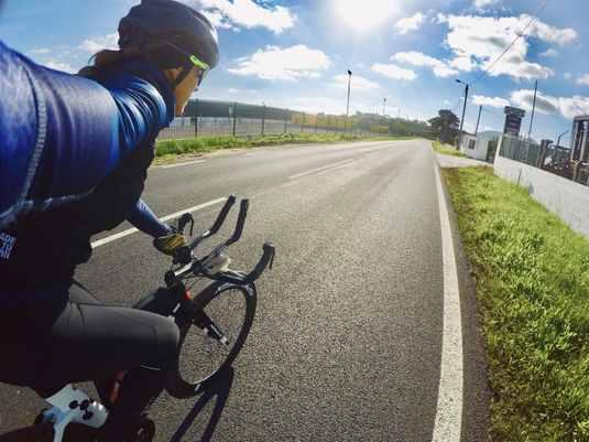 Athlete riding a bike, having a selfie