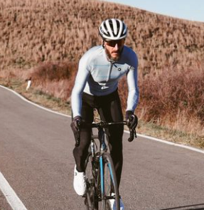 Athlete in long sleeves biking in the desert. Hammer Nutrition Ambassador
